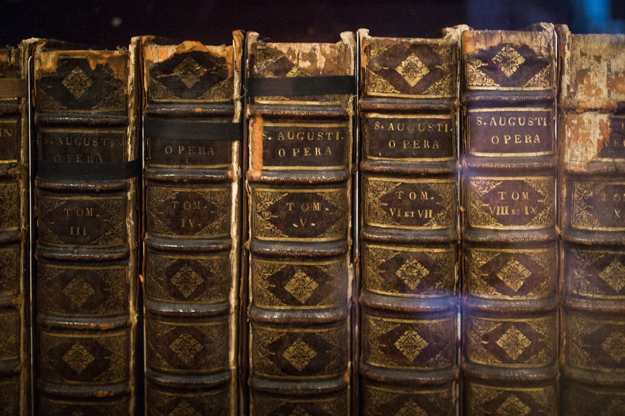 Close-up of vintage St. Augustine's Opera books, showcasing their aged and classic bindings.